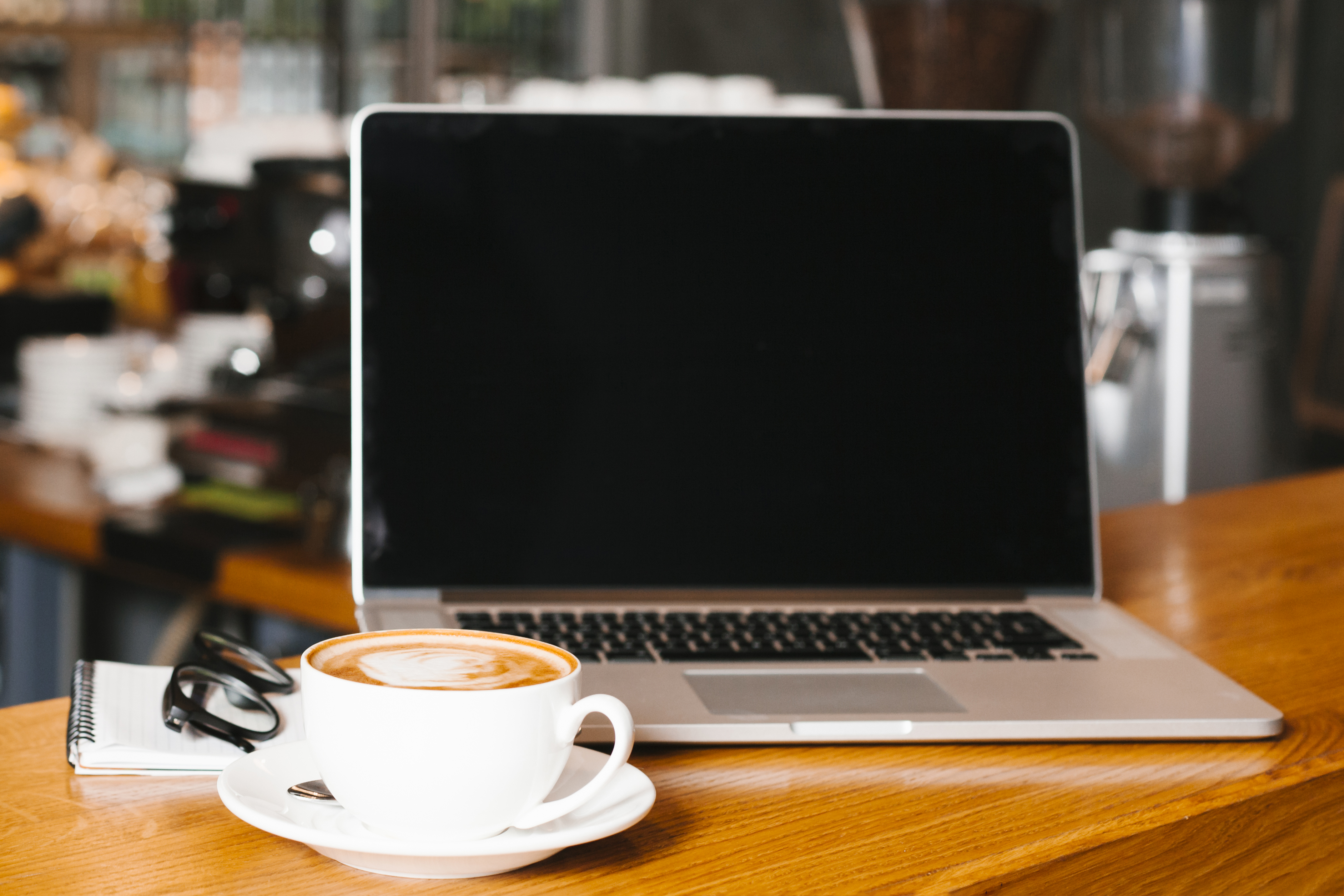 Laptop and coffee on wooden surface